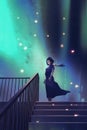 The woman in a dark blue dress standing on stairs