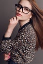 Woman with dark hair in elegant leopard print shirt and with glasses Royalty Free Stock Photo