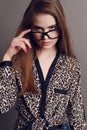 Woman with dark hair in elegant leopard print shirt and with glasses Royalty Free Stock Photo