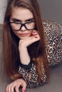 Woman with dark hair in elegant leopard print shirt and with glasses Royalty Free Stock Photo