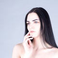 Woman with dark hair touching the cheek by hand. Beauty concept Royalty Free Stock Photo