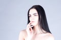 Woman with dark hair touching the cheek by hand. Beauty concept Royalty Free Stock Photo