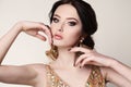 Woman with dark hair wearing luxurious sequin dress and bijou