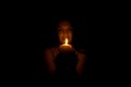 Woman in darkness with candle light