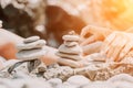 Woman with daughter bilds stones pyramid on seashore on a sunny day on the blue sea background. Happy family holidays Royalty Free Stock Photo