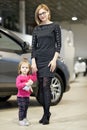 Woman with daughter choose car