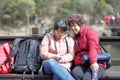 Woman and daughter play phone by lake of jiuxianshan mountain, adobe rgb