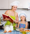 Woman and daughter preparing eggs Royalty Free Stock Photo