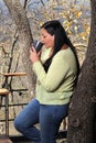 Woman at dawn in a cabin in the woods drinks coffee to activate the mind with caffeine because it is rich in antioxidants