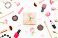 Woman day composition with gift box, roses buds, cosmetics and brushes on white background. Top view. Flat lay. Royalty Free Stock Photo