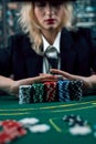 Woman dealer or croupier shuffling poker cards in casino holding two playing cards. Casino. poker