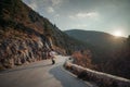 The woman is dear to the mountains. A woman in a white sweater, black boots and a hat walks along a winding alpine path Royalty Free Stock Photo