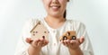 Woman deciding to choose between buying new home or car with Question Marks, Planning to buy property. home loan, car finance