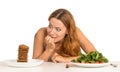 Woman deciding whether to eat healthy food or sweet cookies Royalty Free Stock Photo