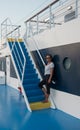 Woman on deck of ferry boat standing on stairs Royalty Free Stock Photo