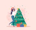 Woman decorate Christmas Tree. Gift boxes are near Christmas Tree. Royalty Free Stock Photo