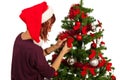 Woman decorate tree with ribbons