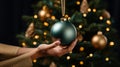 Woman decorates a Christmas tree and hangs a shiny ball on it. Generative Ai