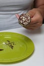 A woman decorates with the help of dark chocolate popcake glazed with white chocolate Royalty Free Stock Photo