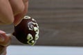 A woman decorates with the help of white chocolate popcake glazed with dark chocolate Royalty Free Stock Photo
