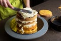 Woman decorating a cake with icing cream