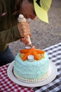 Woman Decorating Cake Outdoors Royalty Free Stock Photo