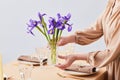 Woman Decorating Dining Table with Irises Minimal