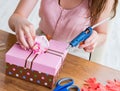 Woman decorating gift box for special occasion