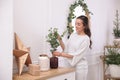 Woman decorating home interior with eucalyptus branches