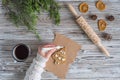 Woman decorating honey gingerbread cookies in a form of christmas tree on wooden grey table and craft paper. Royalty Free Stock Photo