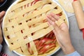 Woman decorating raw apple pie at grey table, top view Royalty Free Stock Photo