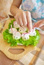 Woman is decorating stuffed eggs