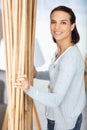 woman by decorative stack bamboo canes