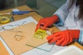 Woman decorator making glass gift box at workshop - close up view