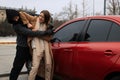 Woman defending herself from attacker near car outdoors Royalty Free Stock Photo