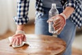 woman degreasing old table surface with solvent Royalty Free Stock Photo