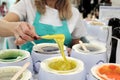 A woman demonstrates wax yellow color for epilation. There are many different colors and compositions to choose from