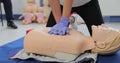 Woman demonstrating CPR on mannequin in first aid class. Royalty Free Stock Photo