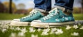 Woman in denim and blue sneakers standing in vibrant green grass, symbolizing spring awakening