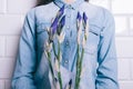 Woman in a denim shirt holding a bouquet of unblown flowers iris Royalty Free Stock Photo