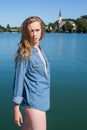 Woman in Denim Shirt Standing by Quiet Lake