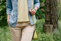 Woman in denim shirt and a yellow T-shirt and pants walking on the green park Royalty Free Stock Photo