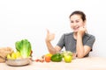 Woman with dental braces showing thumb up while eating salad