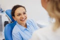 Woman in dental chair having conversation with doctor Royalty Free Stock Photo