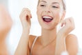 Woman with dental floss cleaning teeth at bathroom Royalty Free Stock Photo