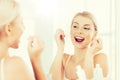 Woman with dental floss cleaning teeth at bathroom Royalty Free Stock Photo