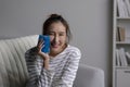 A woman with dental problems uses a cold pack on her cheek to relieve a toothache. Royalty Free Stock Photo