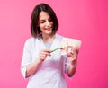 Woman dentist brushing teeth of an artificial skull using a single tufted toothbrush