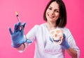 Woman dentist with a carpool syringe injects anesthetic into the gum of the artificial skull