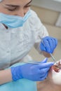 Woman dentist checking her patient for caries. Red-haired woman examined by a doctor. The girl will do the health of the teeth. Royalty Free Stock Photo